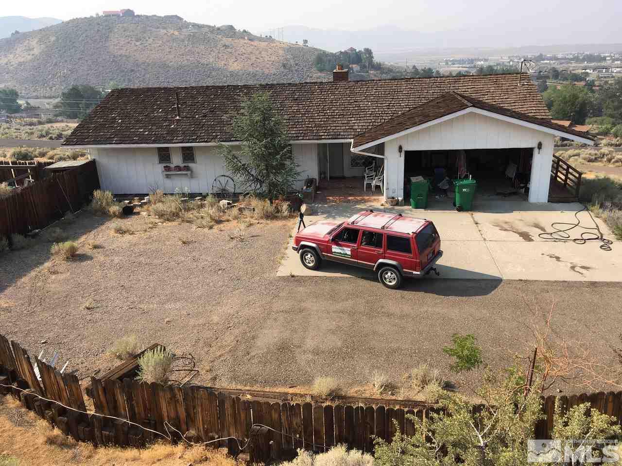 4305 Drake Way Washoe Valley, NV 89704 - Photo 2 of 21 a front view of a house with a yard