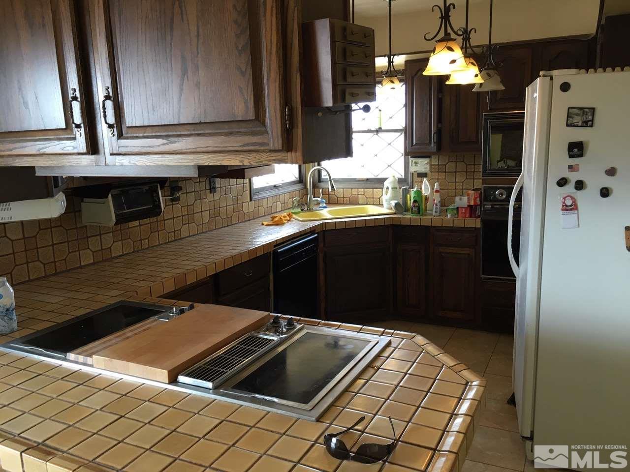 4305 Drake Way Washoe Valley, NV 89704 - Photo 3 of 21 a kitchen with stainless steel appliances kitchen island granite countertop a refrigerator and a sink