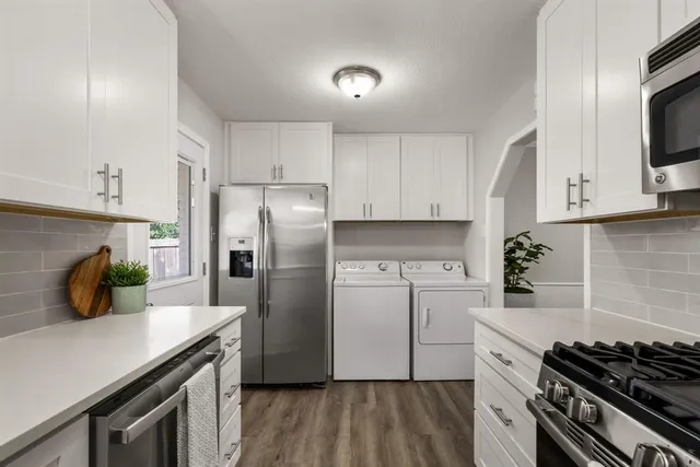 a kitchen with cabinets and steel appliances