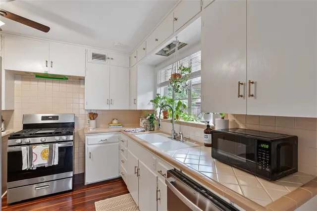 a kitchen with granite countertop a stove and a sink