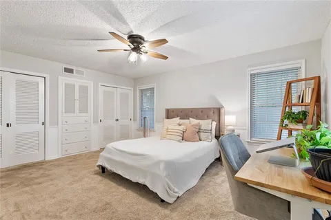 a bedroom with a bed and ceiling fan