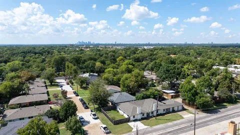 an aerial view of a houses with yard