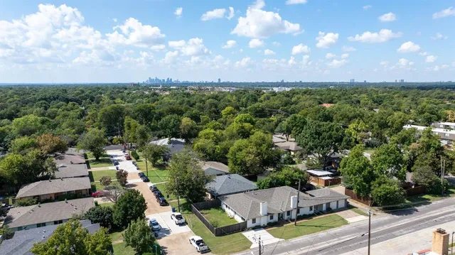 an aerial view of a houses with yard