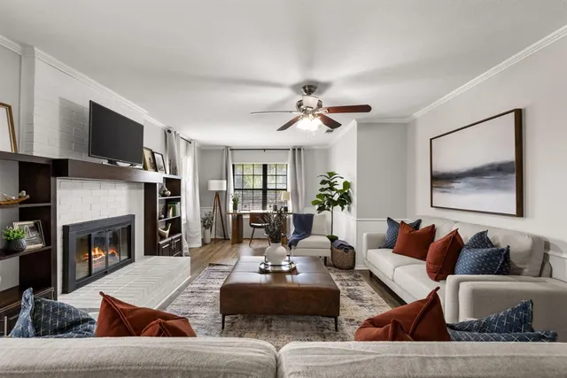 a living room with furniture fireplace and flat screen tv