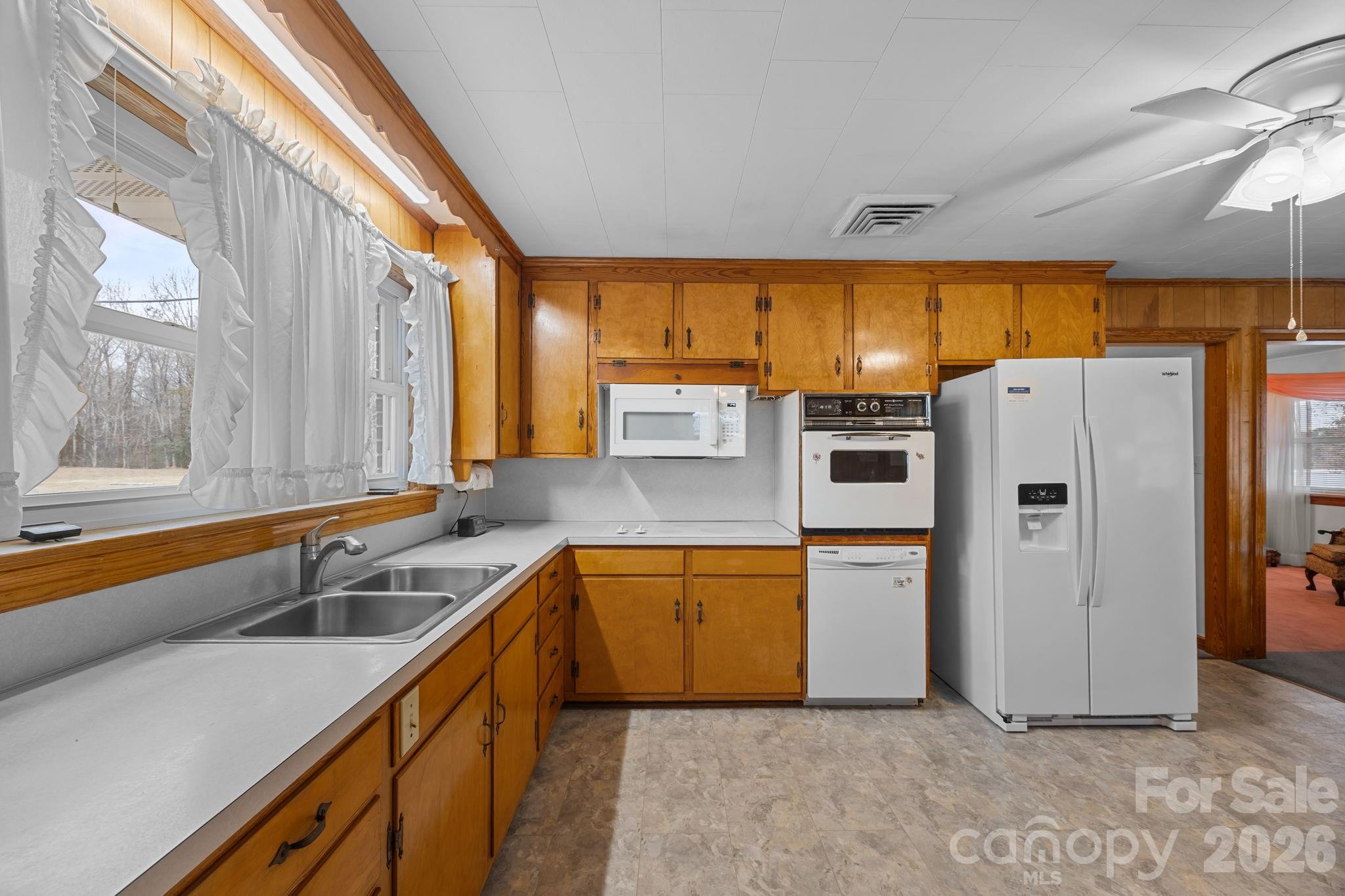 2050 Lake Road Salisbury, NC 28146 - Photo 13 of 41 a kitchen with a refrigerator and a sink