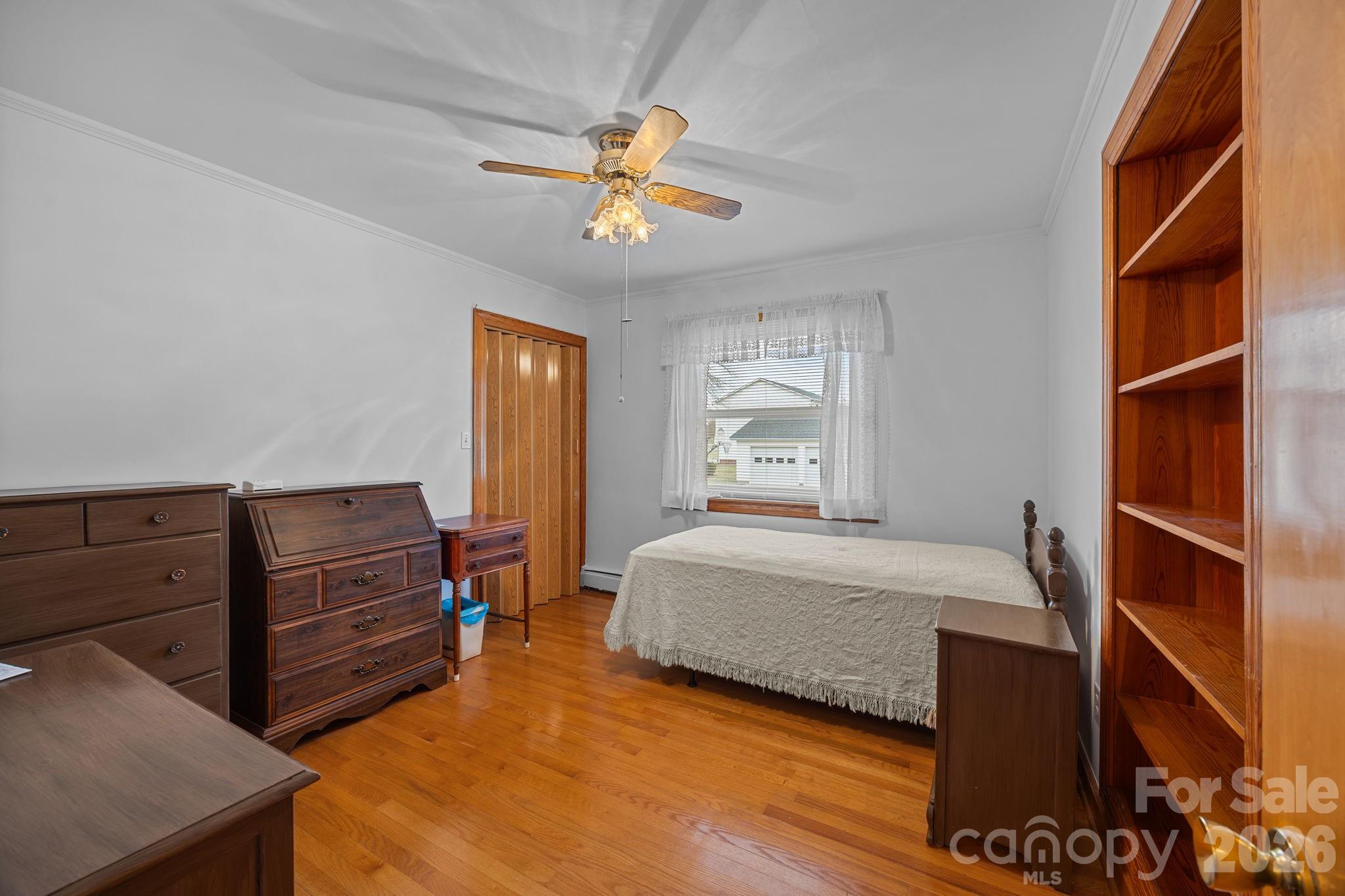 2050 Lake Road Salisbury, NC 28146 - Photo 16 of 41 a bedroom with a bed and a chandelier