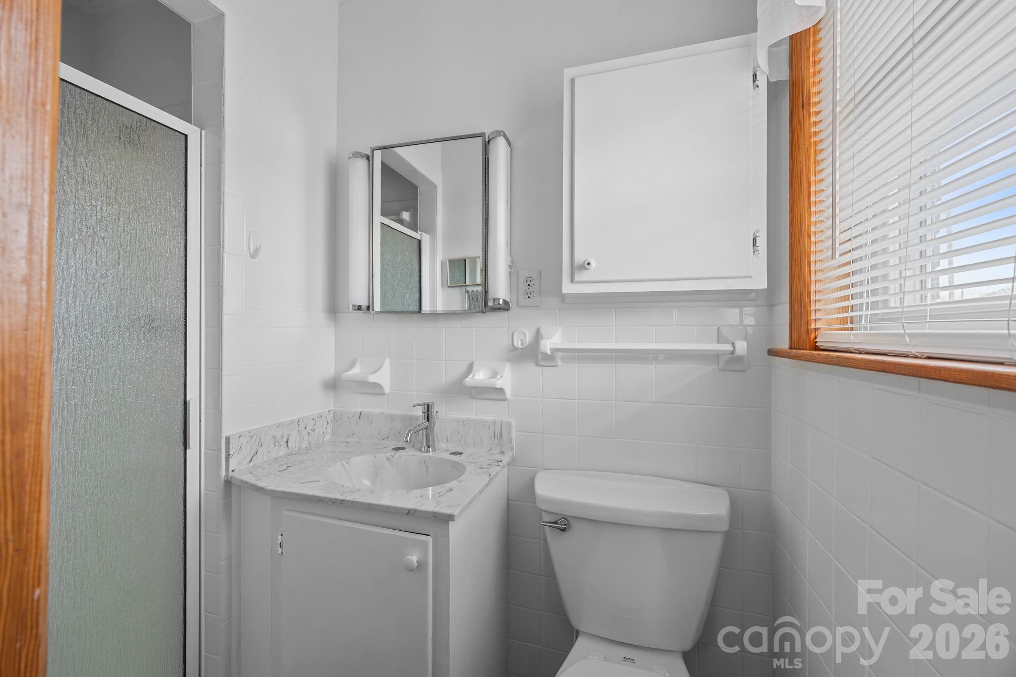 2050 Lake Road Salisbury, NC 28146 - Photo 19 of 41 a bathroom with a toilet sink and mirror