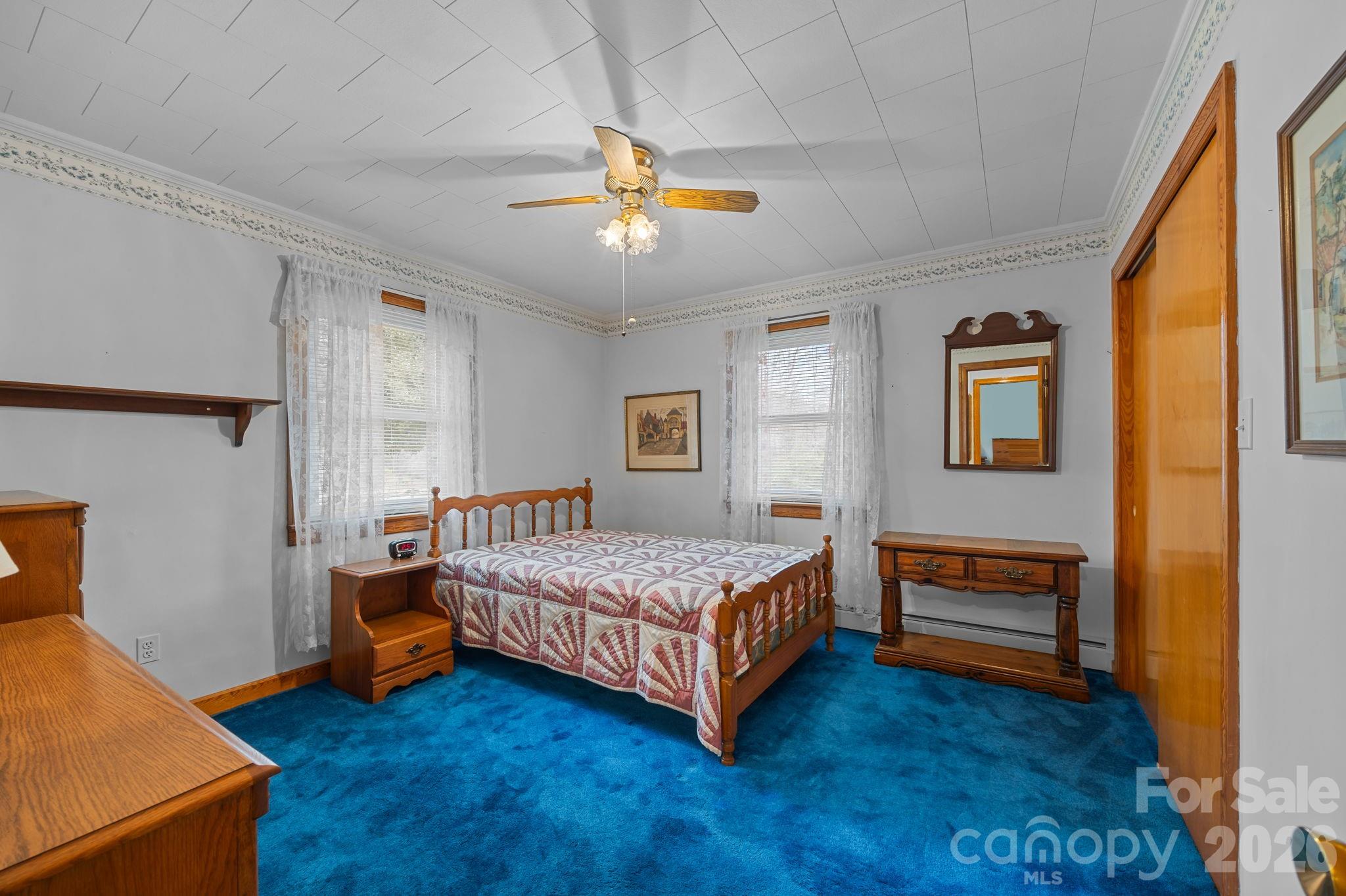 2050 Lake Road Salisbury, NC 28146 - Photo 20 of 41 a room with a bed and a ceiling fan