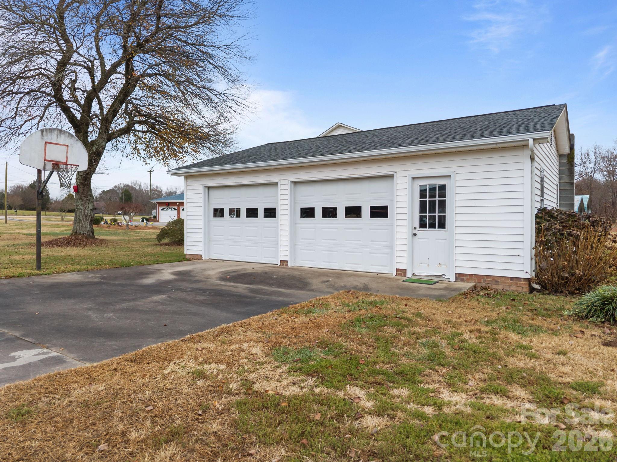 2050 Lake Road Salisbury, NC 28146 - Photo 30 of 41 a view of a white house with a yard and large tree