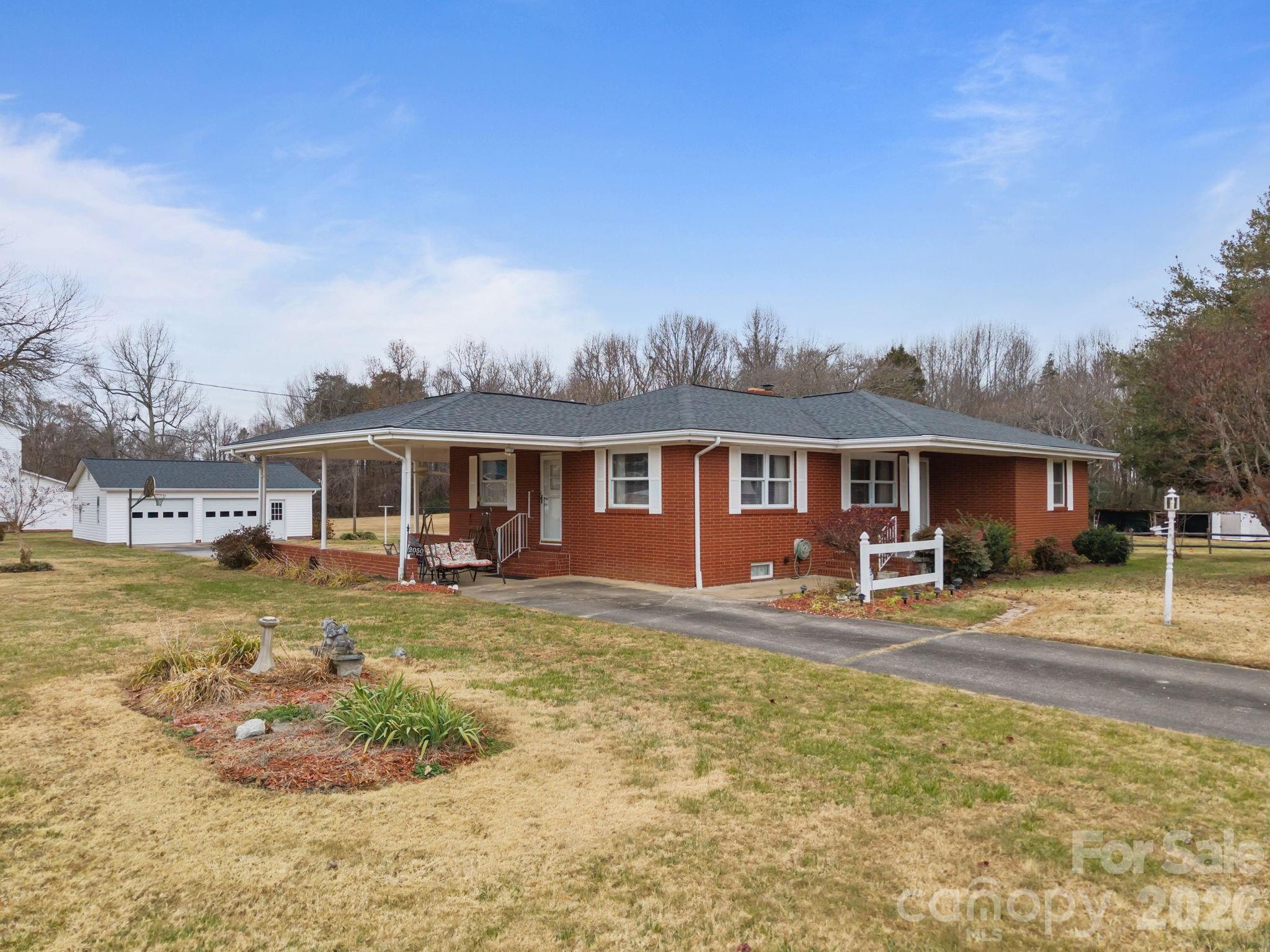 2050 Lake Road Salisbury, NC 28146 - Photo 3 of 41 a front view of a house with garden view and swimming pool