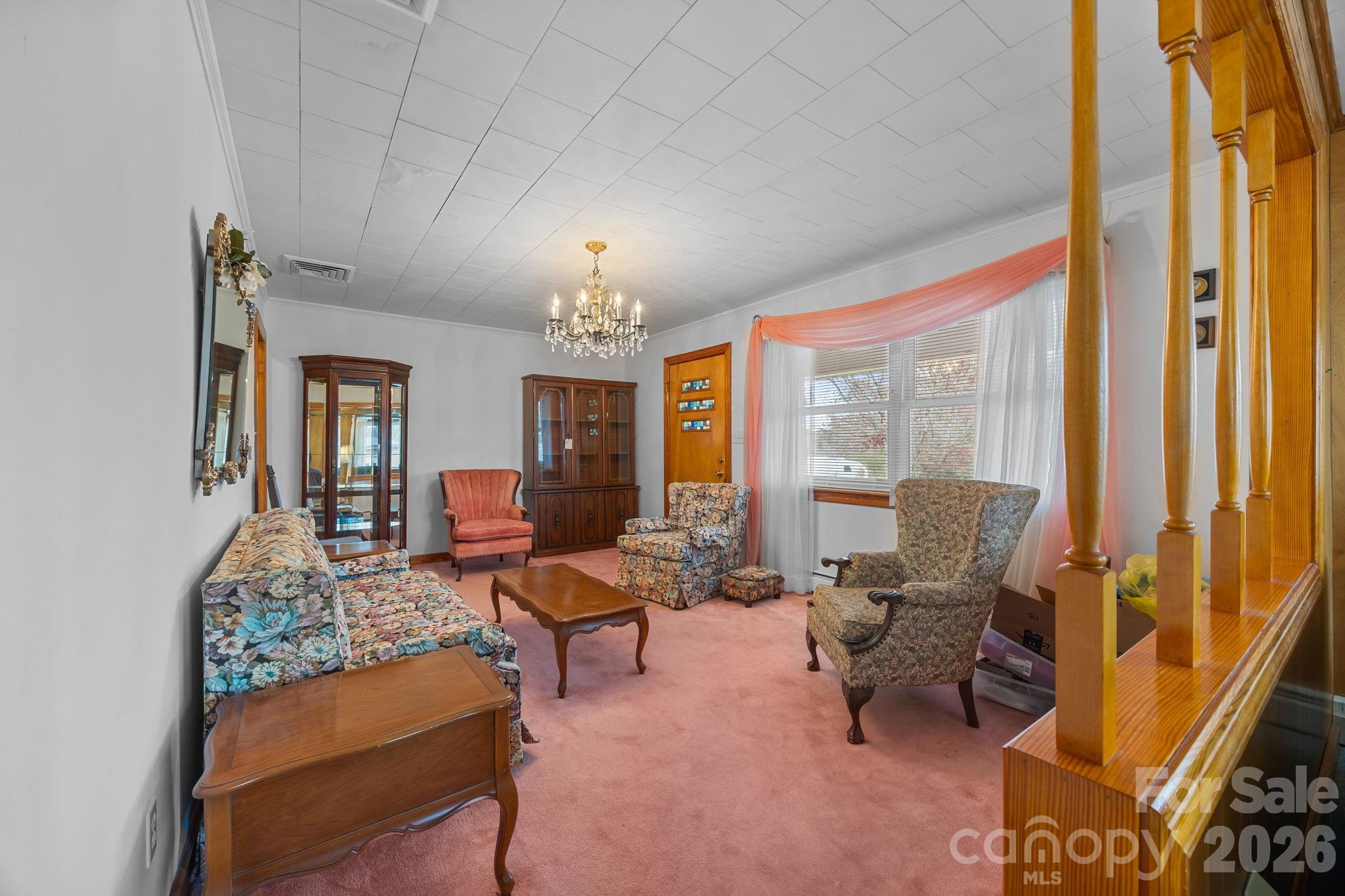 2050 Lake Road Salisbury, NC 28146 - Photo 10 of 41 a living room with furniture and a chandelier