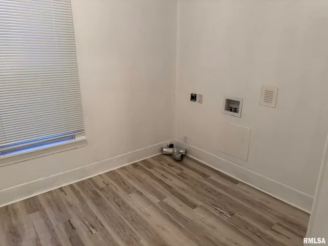 a view of a room with rack on the wall and a window