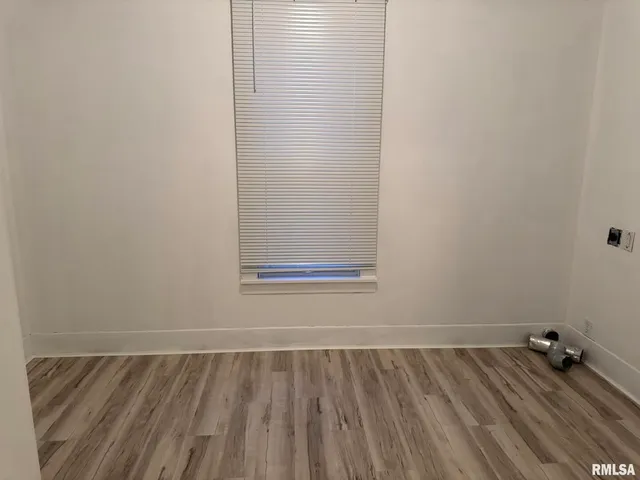 a view of a room with wooden floor and cabinet