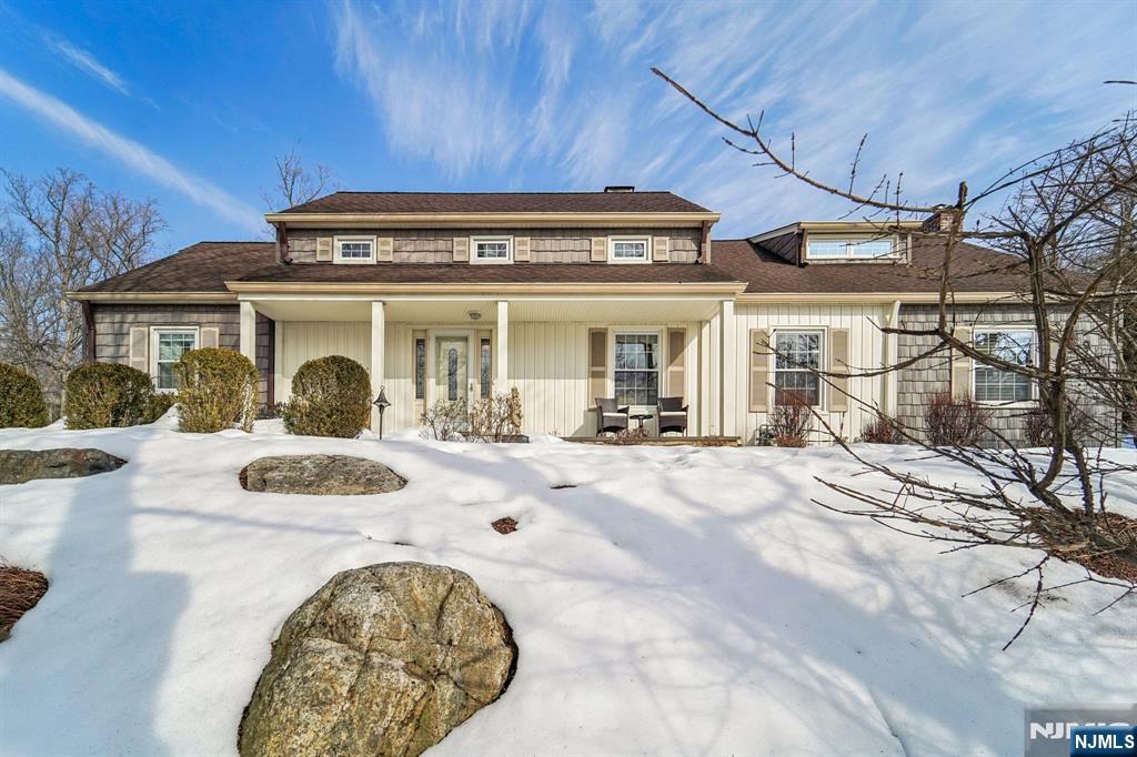 a view of a white house with a swimming pool
