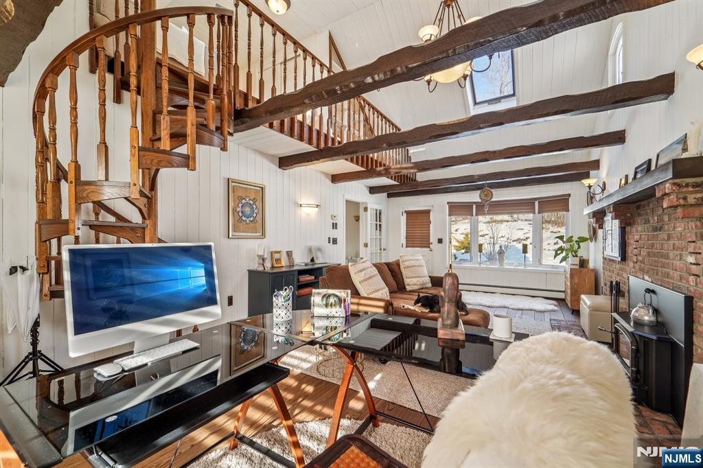 406 Indian Road Wayne, NJ 07470 - Photo 11 of 41 a living room with furniture a flat screen tv and a stove