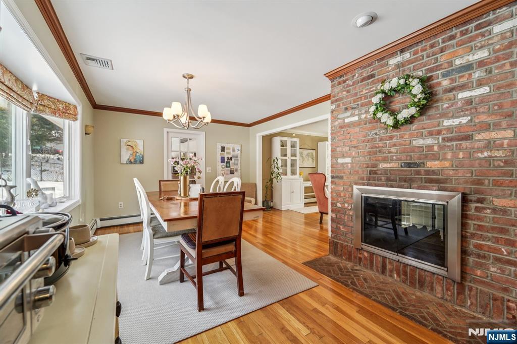 406 Indian Road Wayne, NJ 07470 - Photo 12 of 41 a view of a dining room with furniture window and wooden floor
