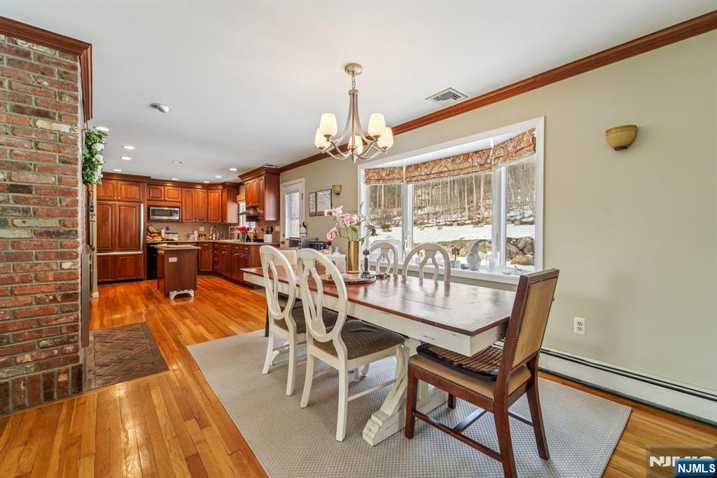 406 Indian Road Wayne, NJ 07470 - Photo 14 of 41 a dining room with furniture and wooden floor