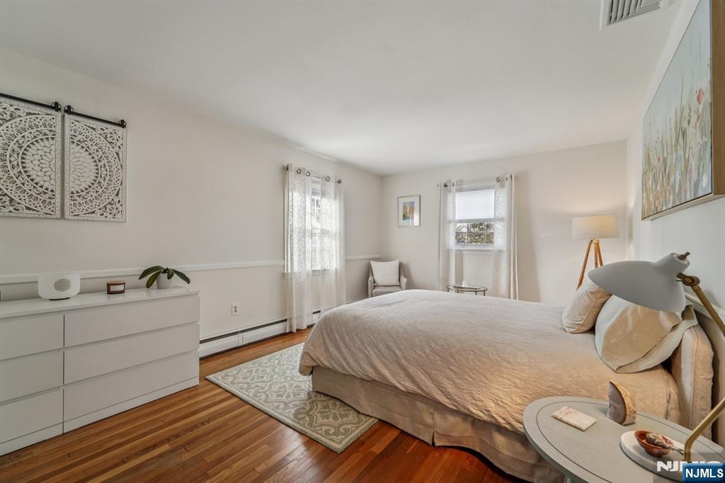 406 Indian Road Wayne, NJ 07470 - Photo 17 of 41 a bedroom with a bed and wooden floor