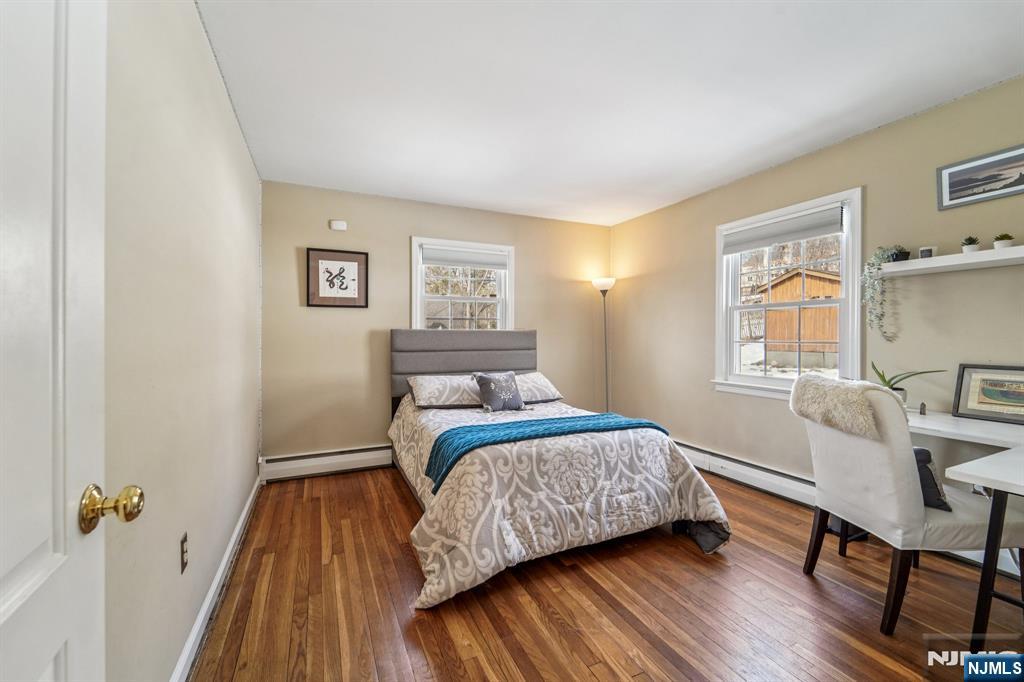 406 Indian Road Wayne, NJ 07470 - Photo 18 of 41 a bedroom with a bed and a table in it