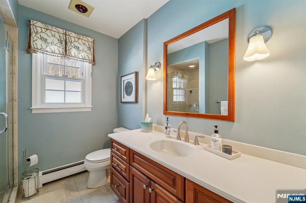406 Indian Road Wayne, NJ 07470 - Photo 19 of 41 a bathroom with a granite countertop sink toilet and mirror