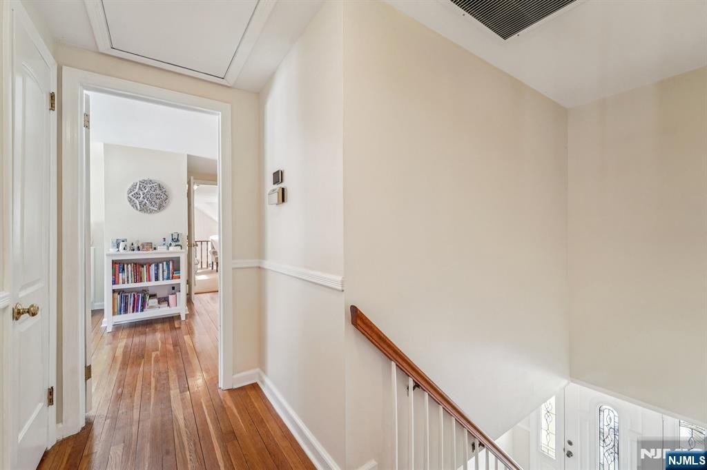 406 Indian Road Wayne, NJ 07470 - Photo 21 of 41 a view of a hallway with wooden floor and staircase