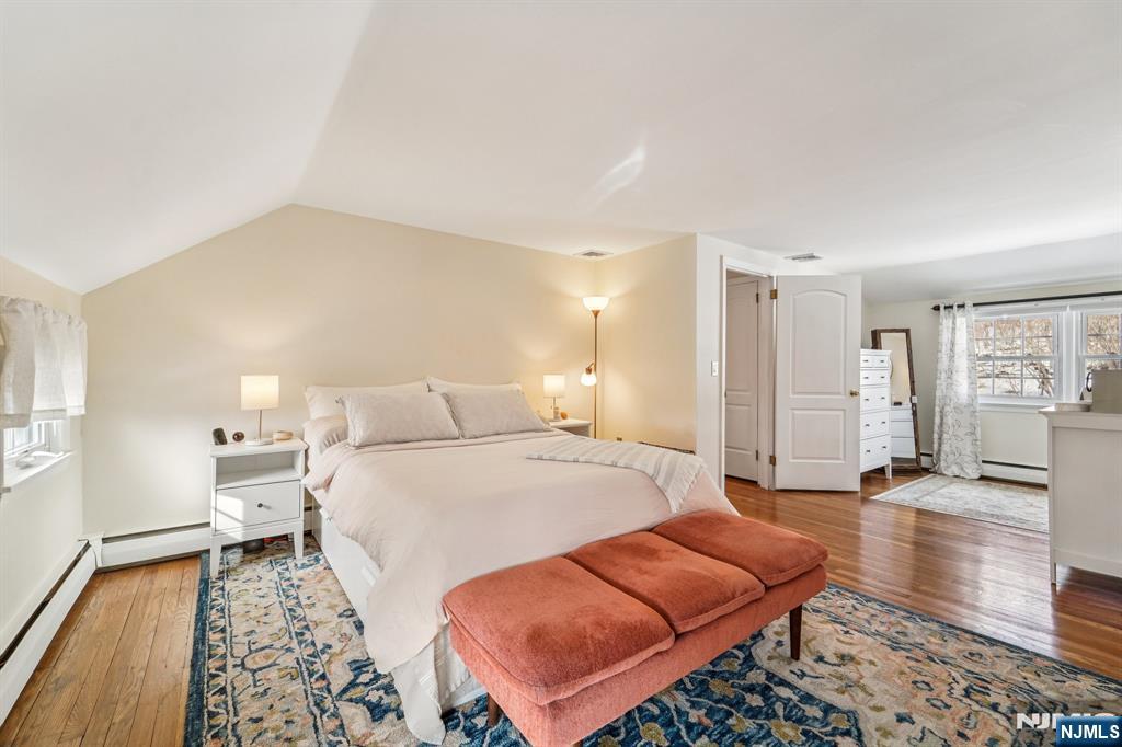 406 Indian Road Wayne, NJ 07470 - Photo 22 of 41 a spacious bedroom with a bed and wooden floor