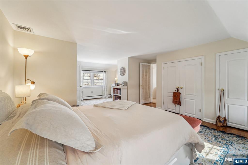 406 Indian Road Wayne, NJ 07470 - Photo 23 of 41 a bedroom with a bed and a mirror