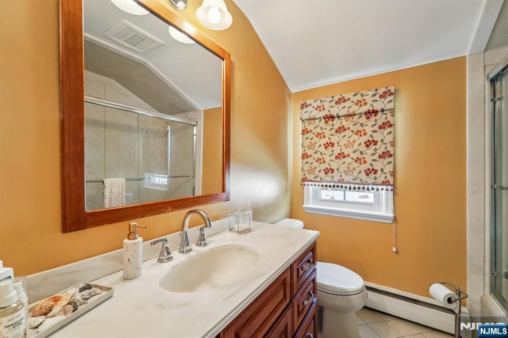 406 Indian Road Wayne, NJ 07470 - Photo 27 of 41 a bathroom with a sink toilet and a mirror