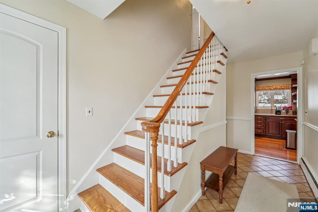 406 Indian Road Wayne, NJ 07470 - Photo 5 of 41 a view of entryway with wooden floor and stairs