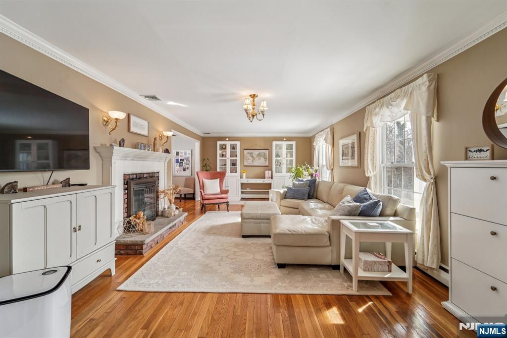 406 Indian Road Wayne, NJ 07470 - Photo 7 of 41 a living room with furniture fireplace and a flat screen tv