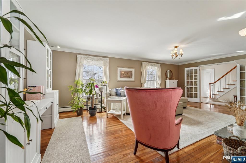406 Indian Road Wayne, NJ 07470 - Photo 8 of 41 a living room with furniture a large window and wooden floor