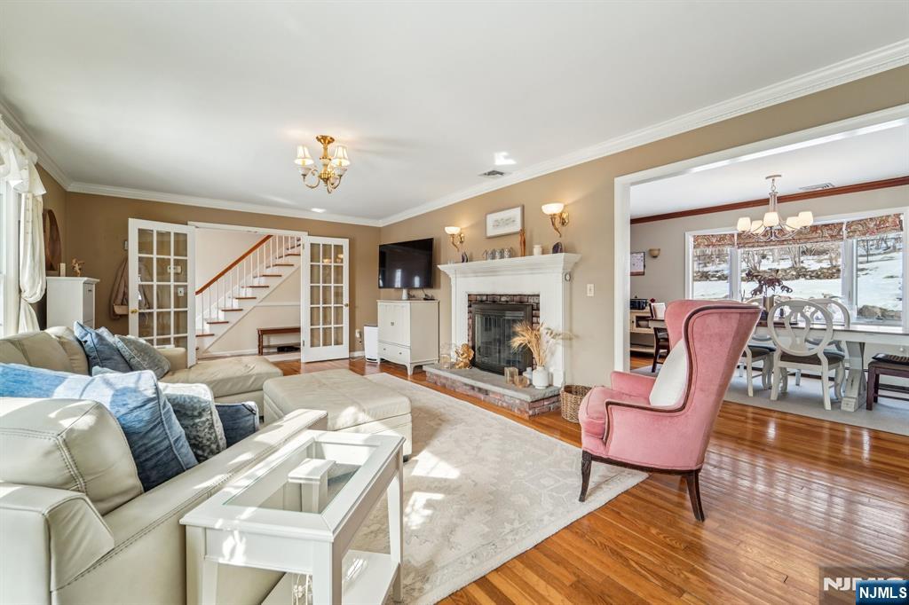 406 Indian Road Wayne, NJ 07470 - Photo 9 of 41 a living room with furniture a fireplace and a floor to ceiling window
