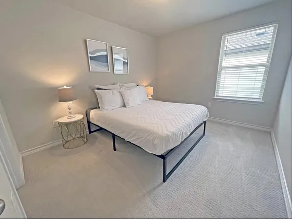 a bed room with a bed and a night stand