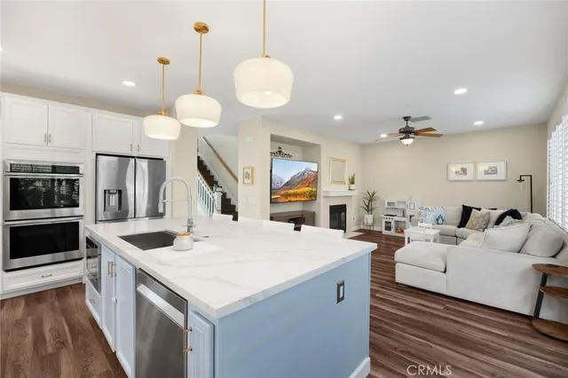 a large white kitchen with a large window