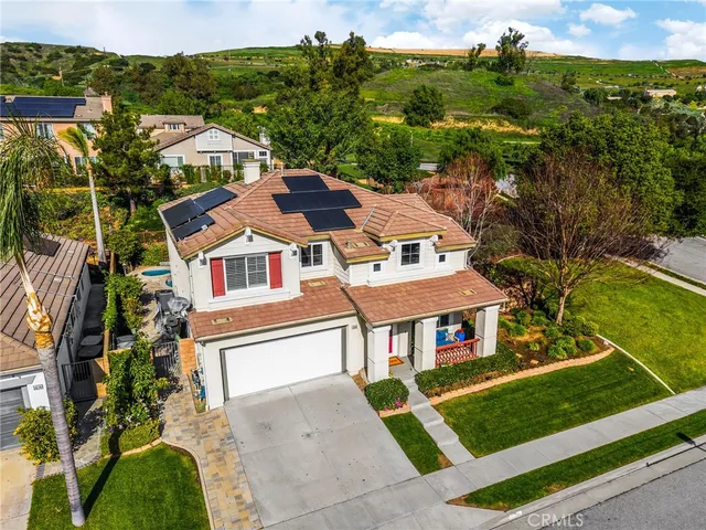 an aerial view of a house with a yard