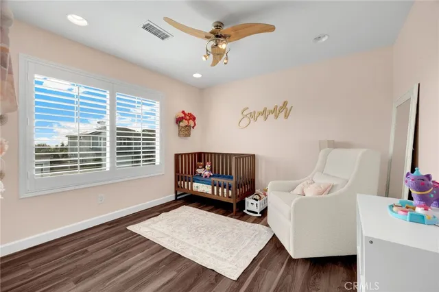 a bedroom with furniture and a wooden floor