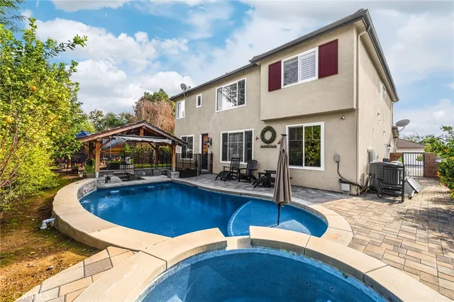 an outdoor sitting area with couch and umbrella