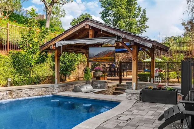 a front view of a house with swimming pool and porch