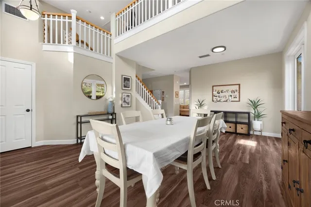 a view of a a dining room with furniture window and wooden floor