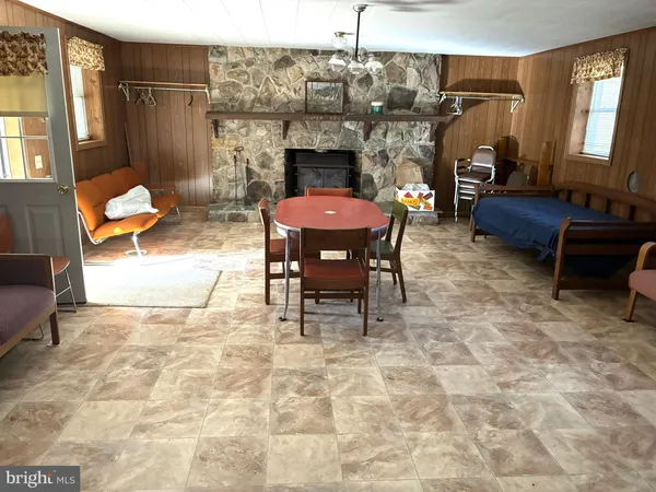 a living room with furniture a fireplace and a table