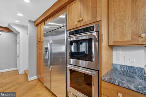 a kitchen with granite countertop cabinets and steel stainless steel appliances