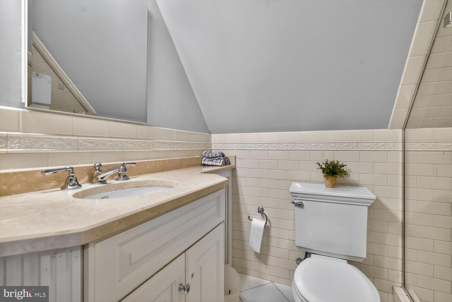 3201 Tennyson Street Northwest Washington, DC 20015 - Photo 29 of 52 a bathroom with a granite countertop toilet sink and mirror