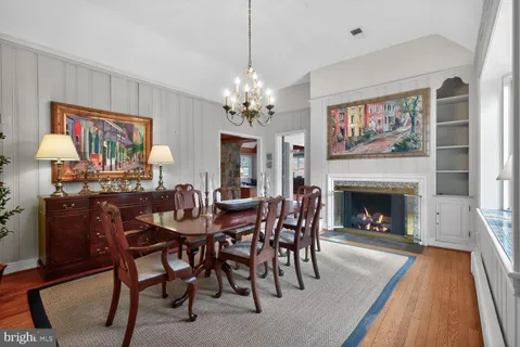 a view of a dining room with furniture wooden floor and a chandelier