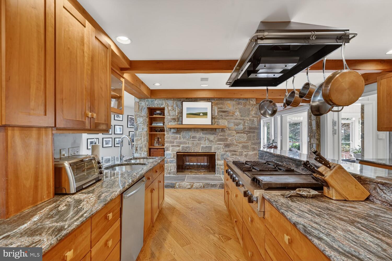 3201 Tennyson Street Northwest Washington, DC 20015 - Photo 8 of 52 a kitchen with stainless steel appliances granite countertop a stove and a wooden cabinets