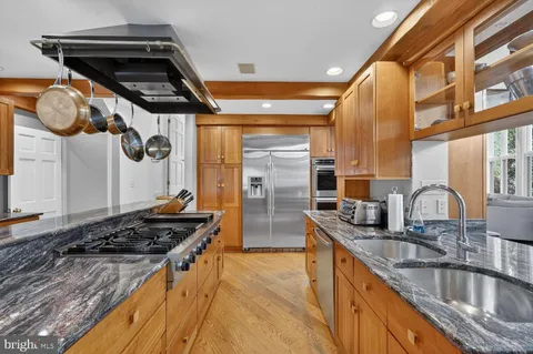 a kitchen with stainless steel appliances granite countertop a stove and a sink