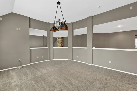 a view of a big room with windows and chandelier