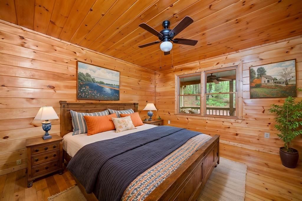 125 Waters Road Ellijay, GA 30536 - Photo 13 of 68 a bedroom with a bed and wooden floor