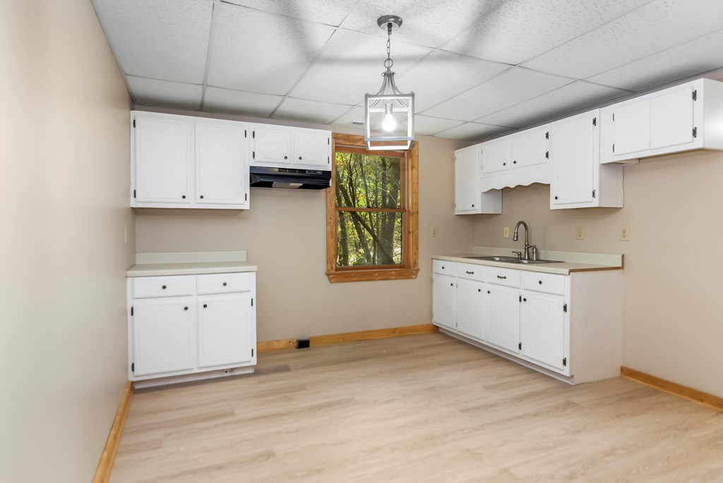 125 Waters Road Ellijay, GA 30536 - Photo 24 of 68 a kitchen with cabinets appliances a sink and a window