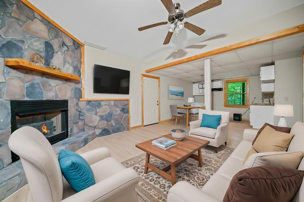 125 Waters Road Ellijay, GA 30536 - Photo 25 of 68 a living room with furniture a flat screen tv and a fireplace