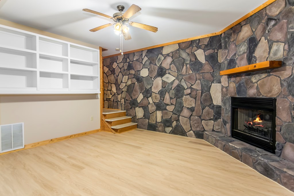 125 Waters Road Ellijay, GA 30536 - Photo 26 of 68 a bedroom with a bed and a fireplace